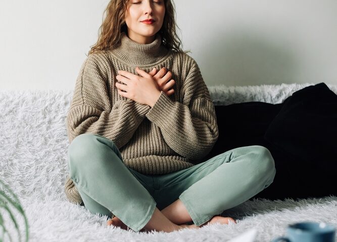 Women grabbing her chest as if she cannot breathe